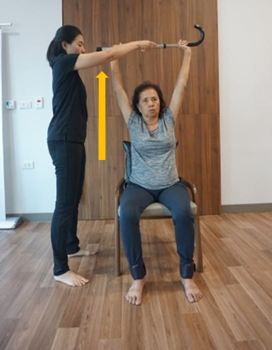 Breathing exercise with chest movement using a walking cane